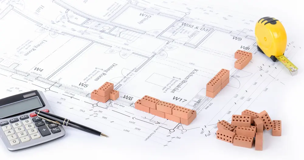 Construction tools and blueprints on a white background.