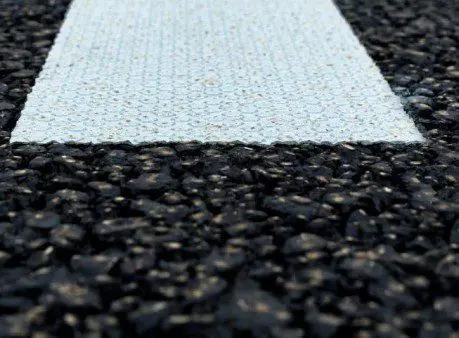 A road with a white and black stripe on it.