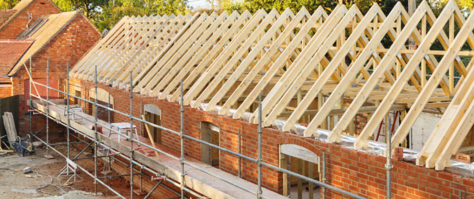 A house under construction with wooden framing.