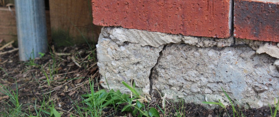 A brick wall with a crack in it.