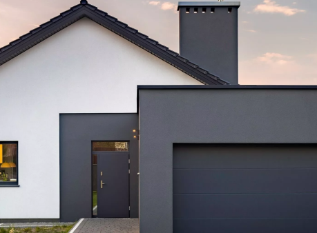 A modern house with a black garage door.